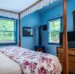 four poster bed with fireplace and tv